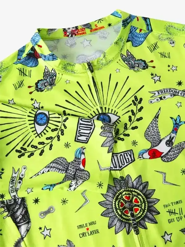 Vibrant neon yellow cycling jersey with tattoo-style graphics, butterflies, birds, and bold text designs