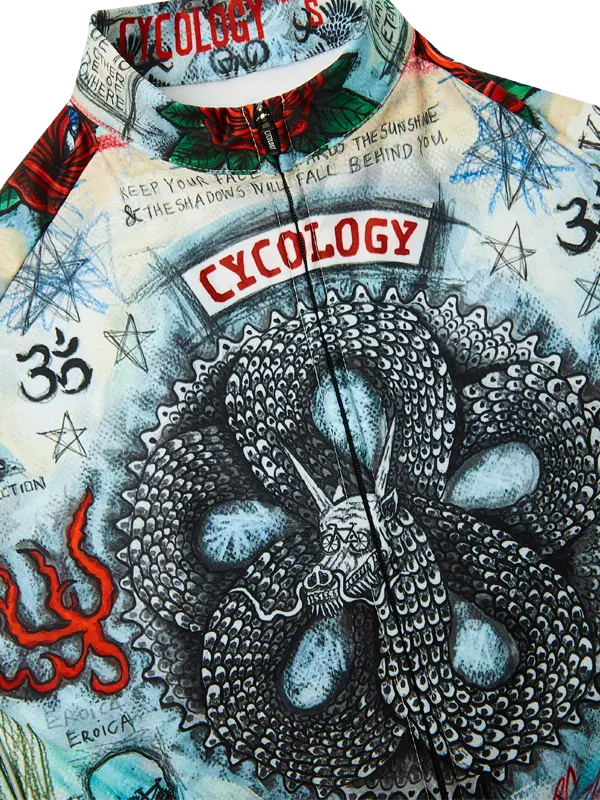 Close-up of a long sleeve cycling jersey  with a detailed design featuring a snake and text, branded 'Cycology'.