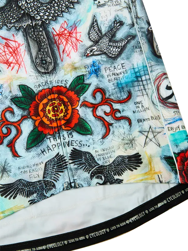 Close-up of a colorful fabric with tattoos, flowers, and text