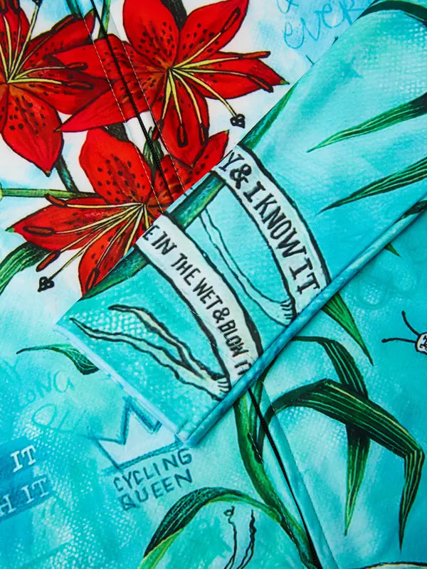 Cycling jersey with floral design and 'Cycology' branding on a aqua background