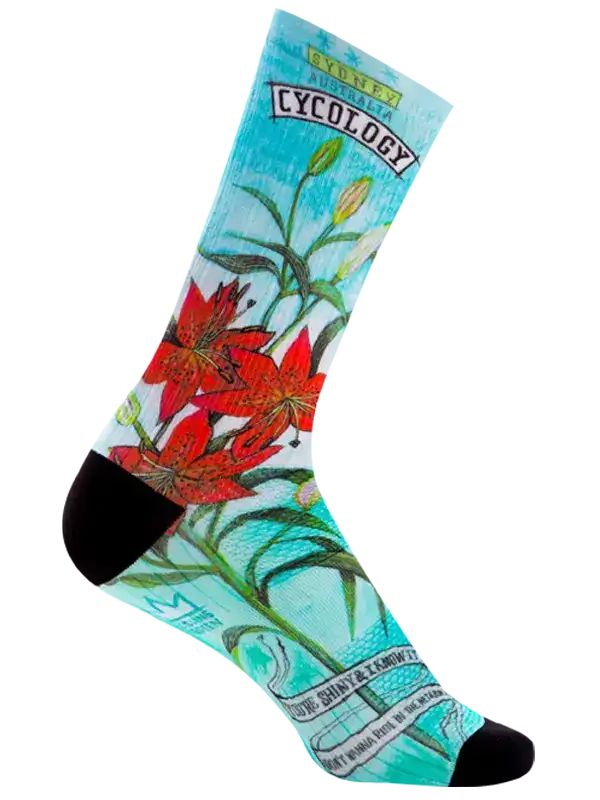 A single crew sock with a light blue background featuring a red lily flower illustration, green stems, and text including 'CYCOLOGY