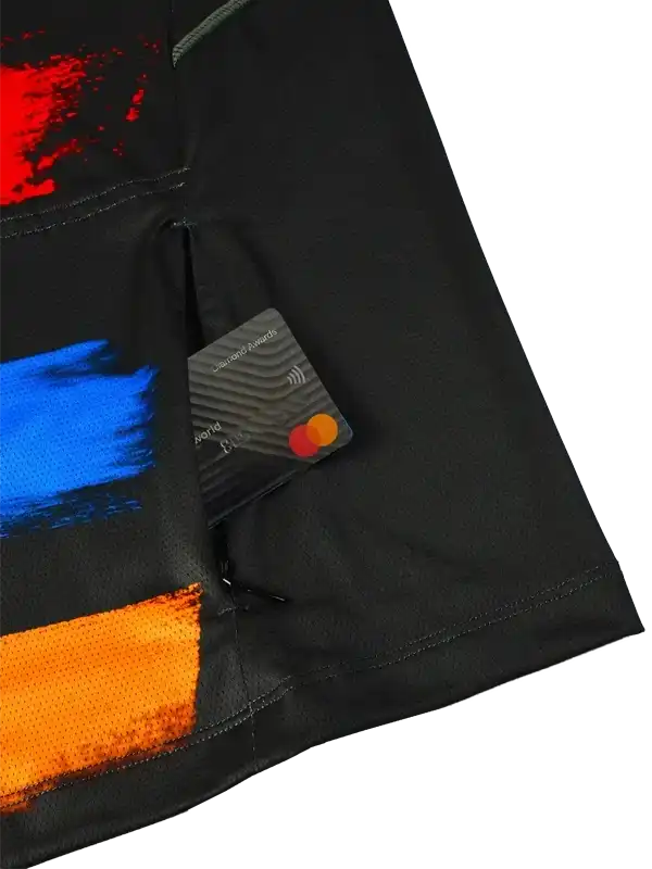 Black cycling jersey with bold red, blue, and orange brushstroke design, featuring secure card pocket
