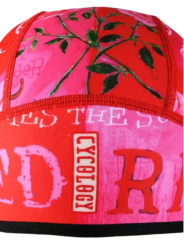 Cycology cycling cap with pink floral print and bold red lettering, designed for women's bike rides