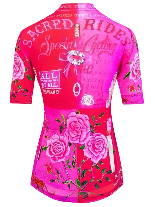 Women's pink cycling jersey with rose print and 'Sacred Rides' text, featuring floral design and motivational phrases.