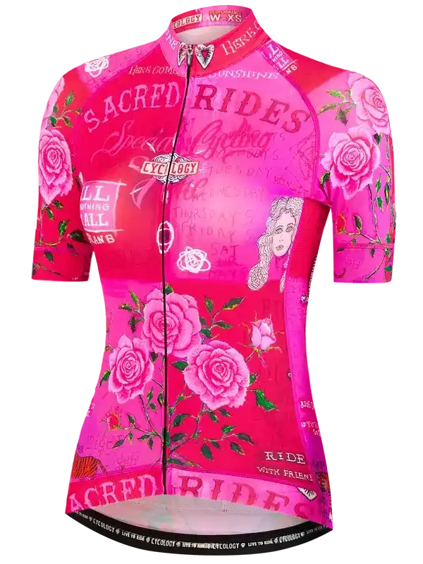Pink women's cycling jersey with rose print and 'Sacred Rides' text, featuring short sleeves and full zip