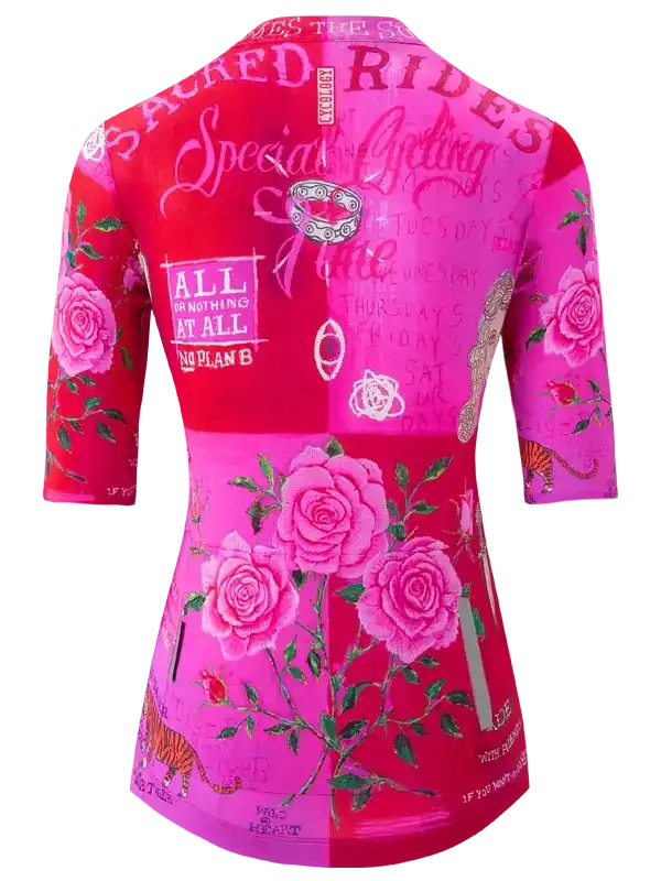 Women's pink cycling jersey with rose print and motivational text, designed for road rides