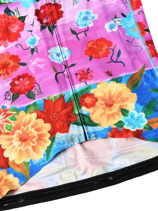 Colorful women's long sleeve  cycling jersey with floral design and 'Cycology' branding on a pink and blue background