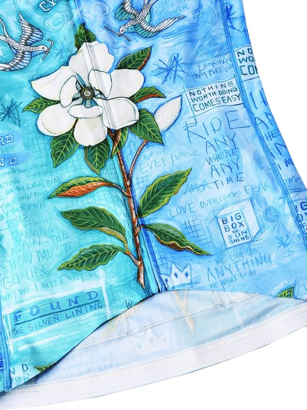 Close up of Blue women's long sleeve cycling jersey with floral and bird design