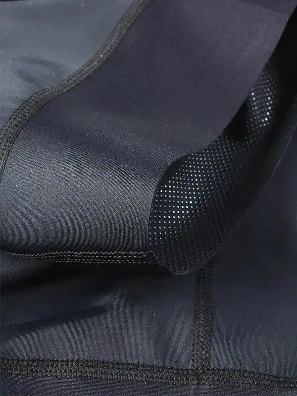 Black cycling bib shorts with perforated padding and flatlock seams for comfort
