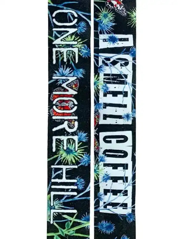 Cycling socks with 'One More Hill I Smell Coffee' text and floral butterfly design on black background