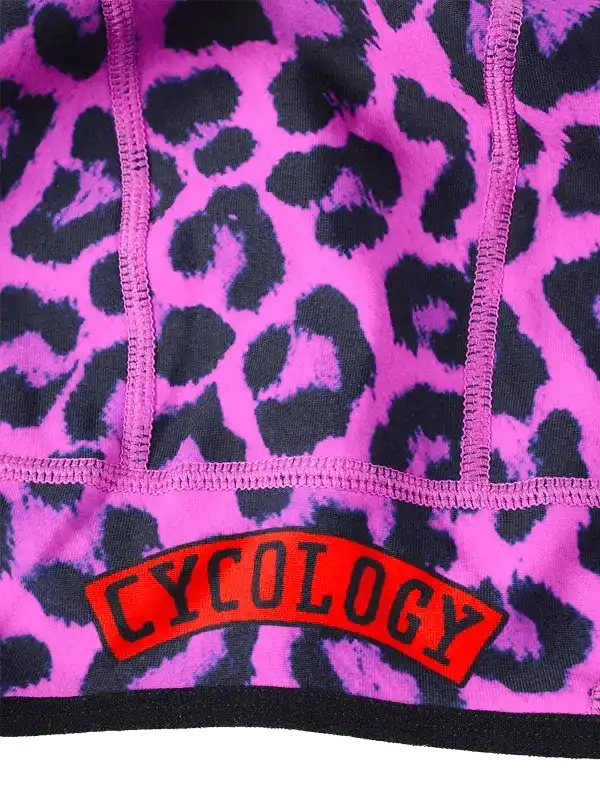 Pink leopard print cycling shorts with red Cycology logo, women's bike wear