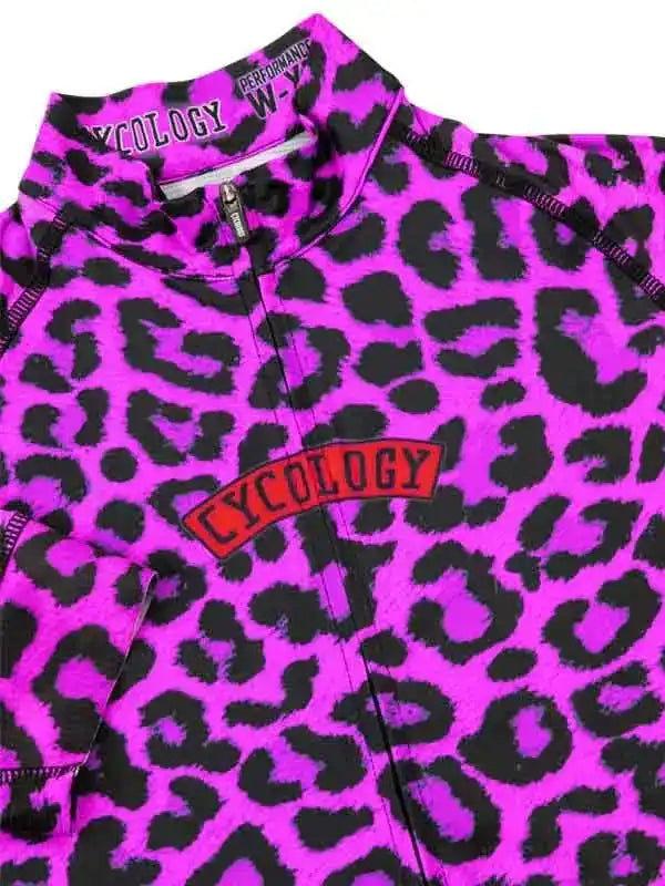 Vibrant pink leopard print cycling jersey with bold 'Cycology' logo, designed for performance and style.
