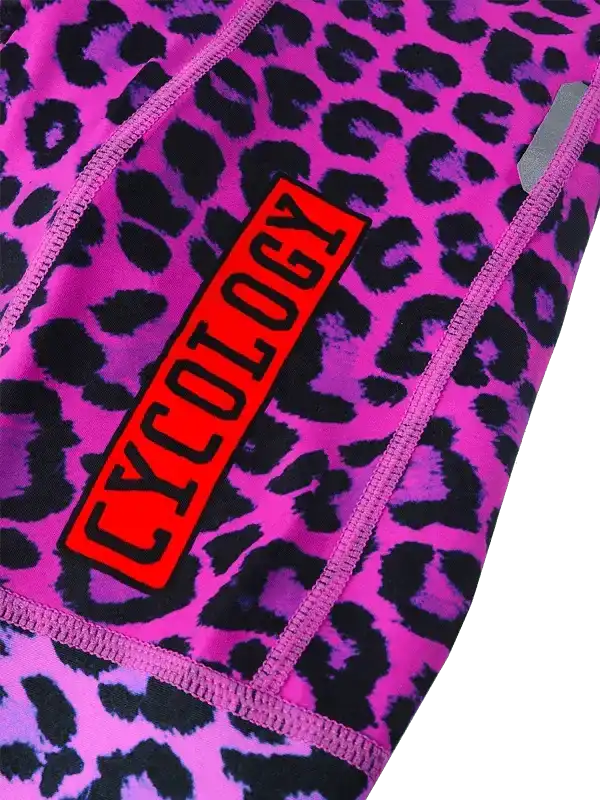 Pink leopard print cycling shorts with bold red Cycology logo, high-quality fabric design