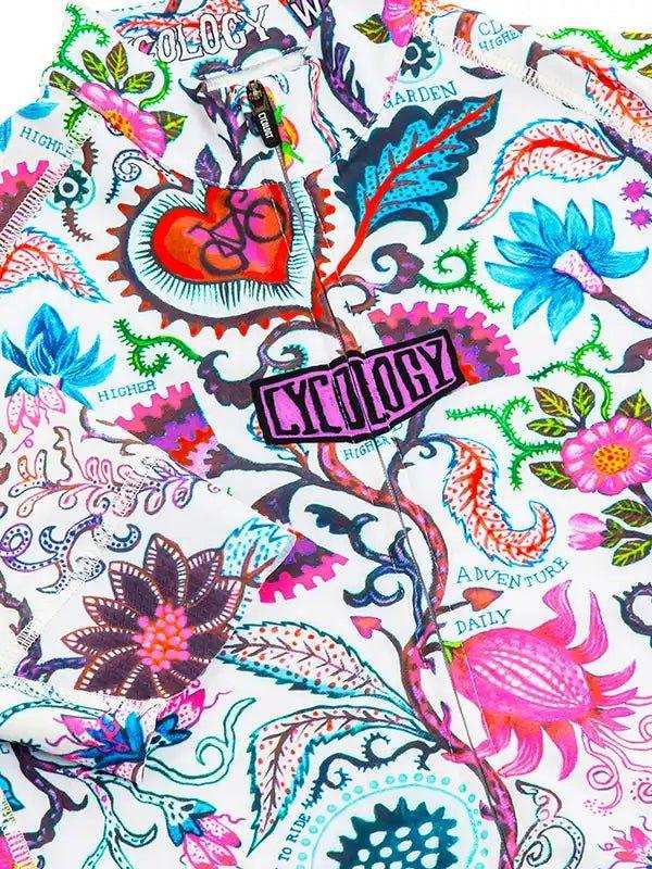 Vibrant floral cycling jersey with bold 'Cycology' logo, heart gear design, and adventure-themed print for men and women.