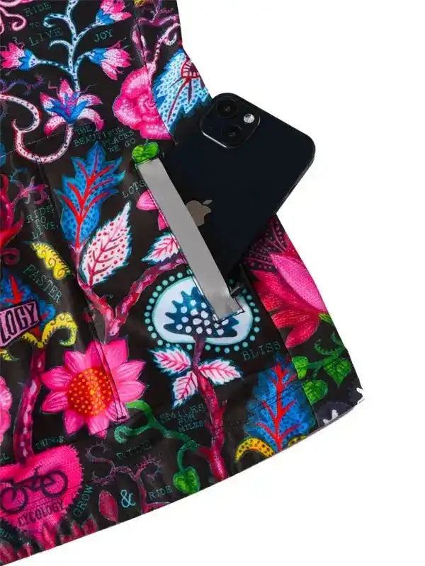 Vibrant floral cycling shorts with phone pocket, featuring bold pink, blue, and green prints for women's bike wear.