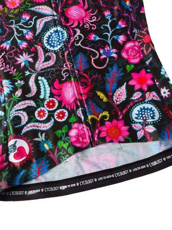 Vibrant floral cycling jersey with pink, blue, and green patterns on black fabric, featuring branded hem