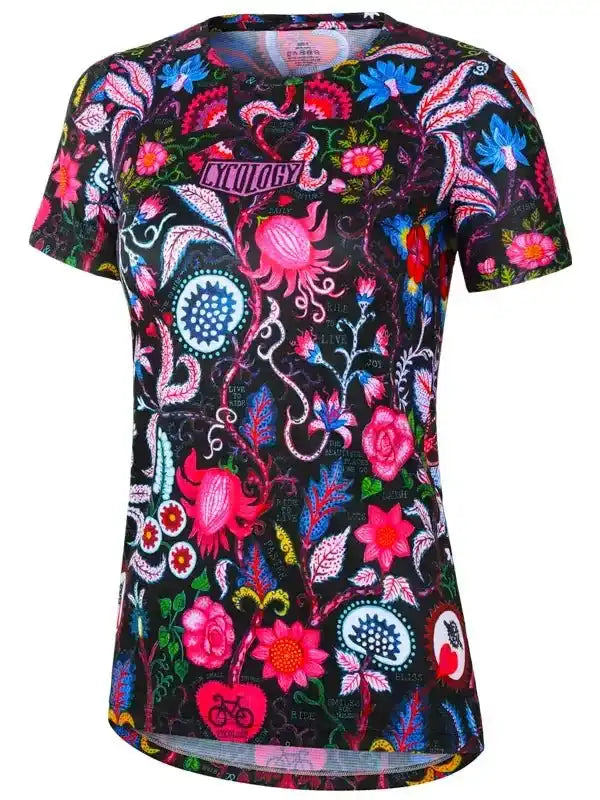Women's cycling jersey with vibrant floral and paisley print, featuring bold pink, blue, and red designs on black fabric.