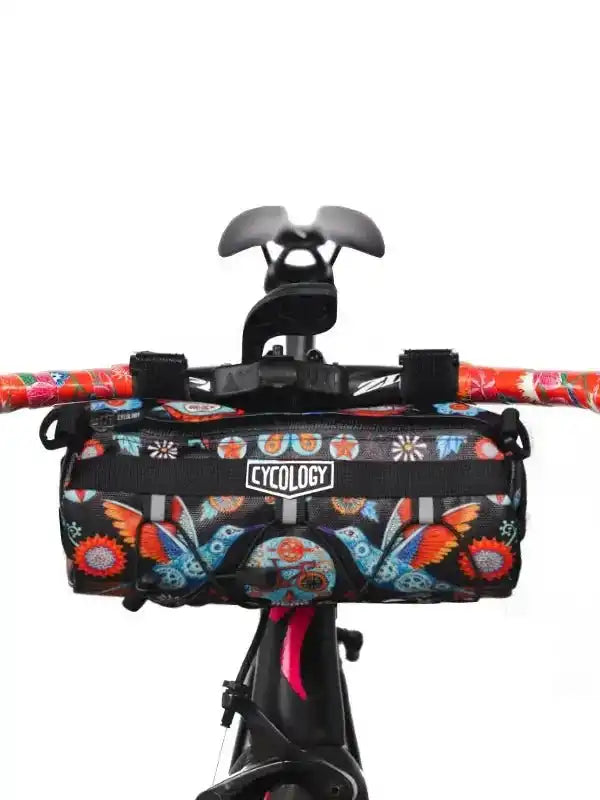Cycology bike handlebar bag with colorful floral and butterfly print, mounted on cycling handlebars