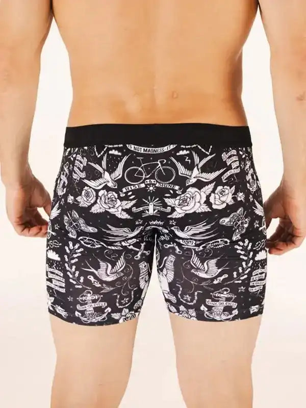 Men's cycling shorts with tattoo-style bird and rose print, black waistband, unique design