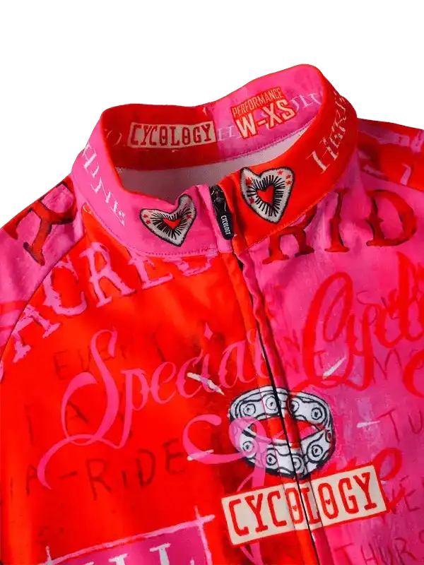 Vibrant pink and red women's cycling jersey with heart graphics, 'Cycology' branding, and performance fit details