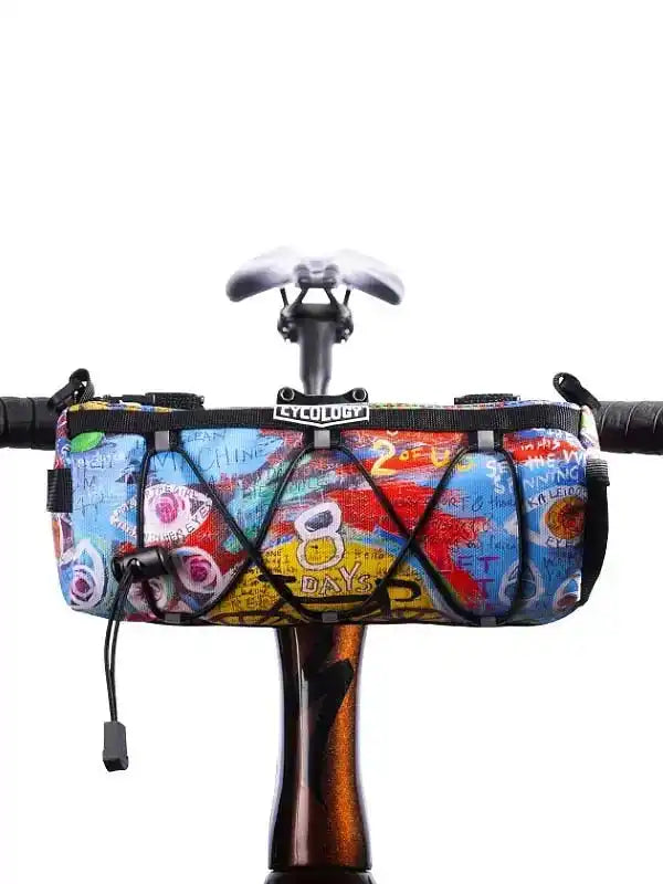 Colorful cycling handlebar bag with graffiti print, mounted on bike frame for road or mountain biking gear storage