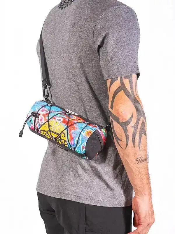 Colorful cycling waist bag with vibrant pattern, worn by man in grey tee for bike rides