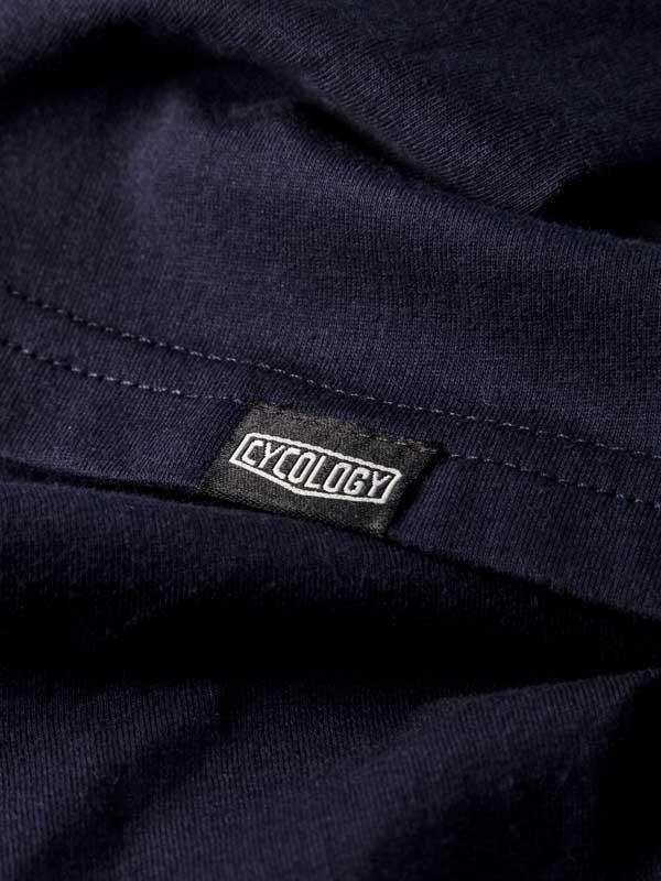 Cycology brand tag on dark navy cycling apparel, showcasing quality fabric and design detail.