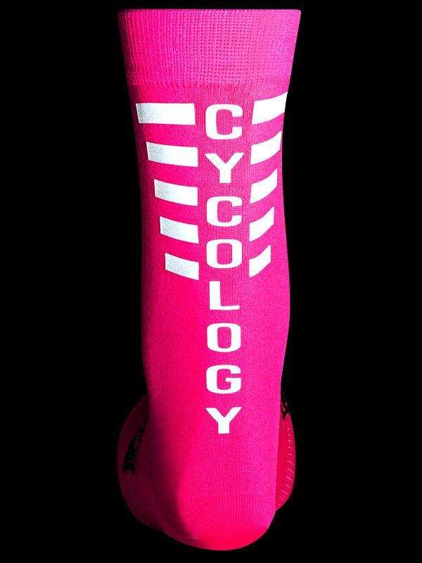 Bright pink cycling sock with white CYCOLOGY text and reflective stripes, ideal for road or mountain biking.