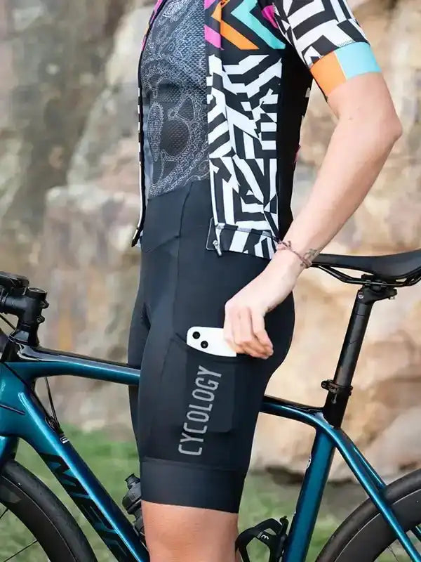 Cycling shorts with phone pocket, geometric print jersey, and road bike outdoors