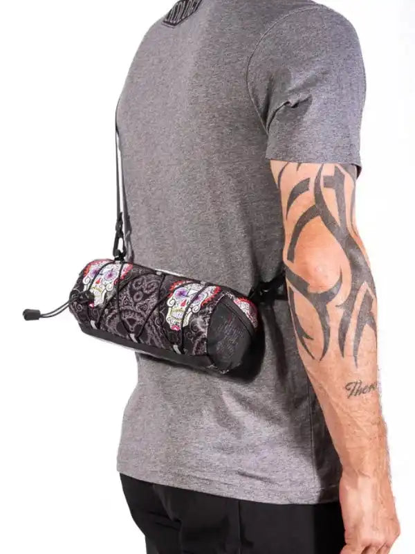 Cycling waist bag with sugar skull print, worn by man in grey tee, ideal for bike rides and outdoor adventures.