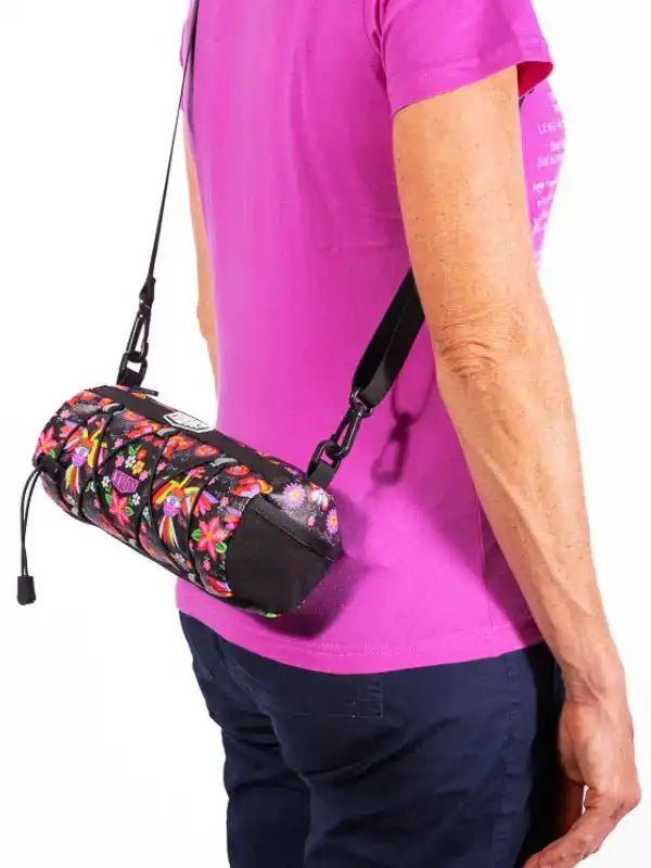 Floral pattern cycling waist bag with adjustable strap worn by woman in pink shirt