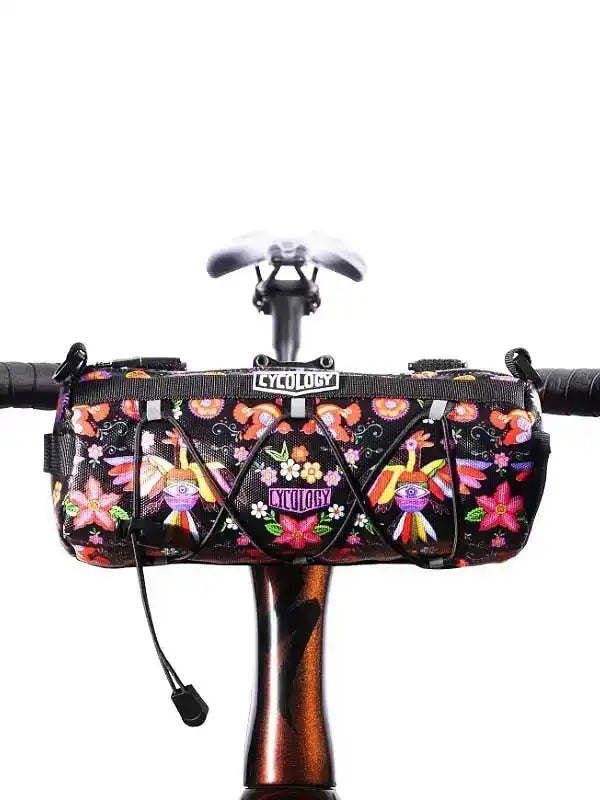 Cycology floral bike frame bag with vibrant hummingbird print, mounted on bicycle handlebars