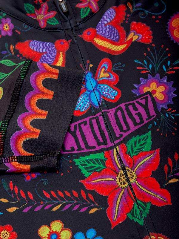 Vibrant floral and bird pattern cycling jersey with bold colors and zipper detail