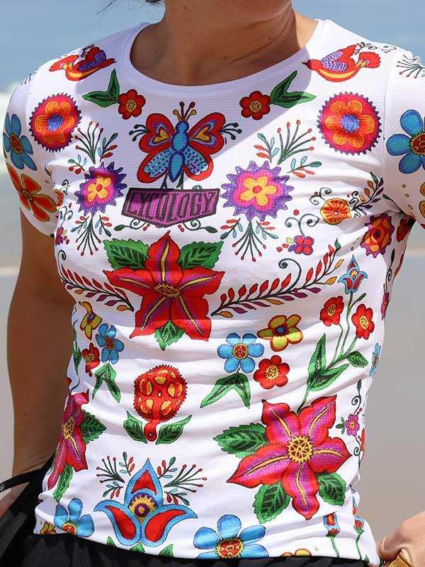 Women's cycling jersey with vibrant floral and butterfly print, colorful design for active wear