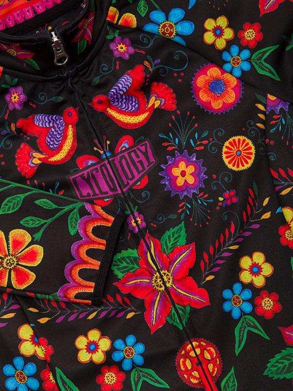 Vibrant floral and bird print cycling jersey with bold colors and intricate patterns