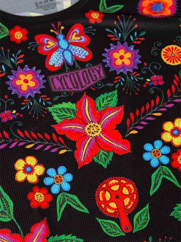 Vibrant floral and butterfly print cycling jersey with bold colors and bike gear motif