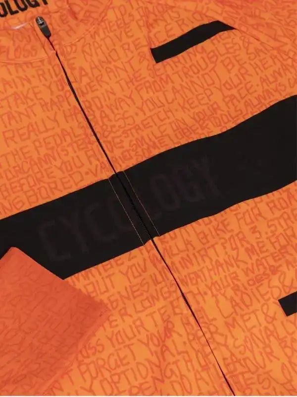Orange cycling jersey with black stripe and motivational text print, designed for men and women riders.