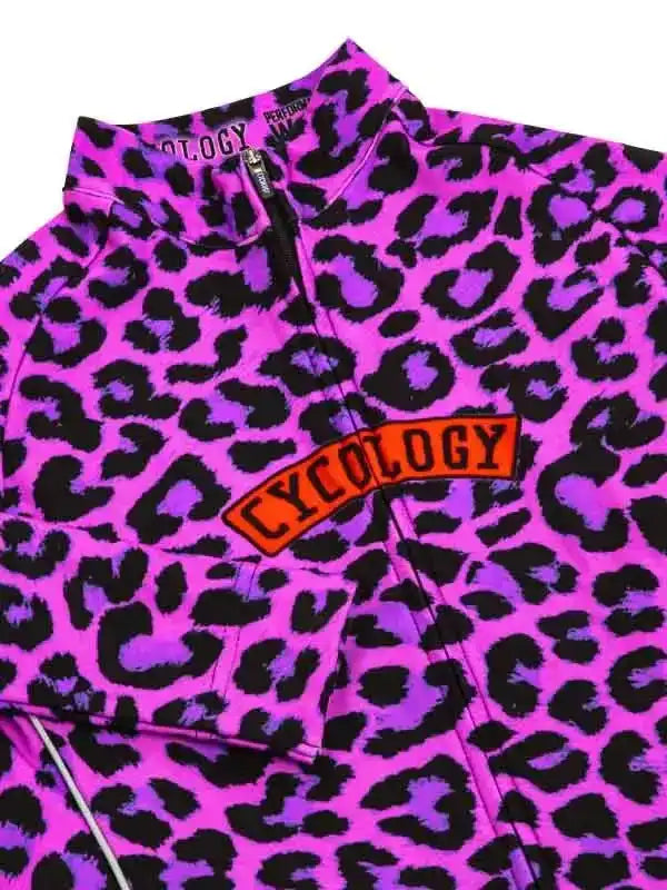 Vibrant pink and purple leopard print cycling jersey with bold 'CYCOLOGY' chest logo