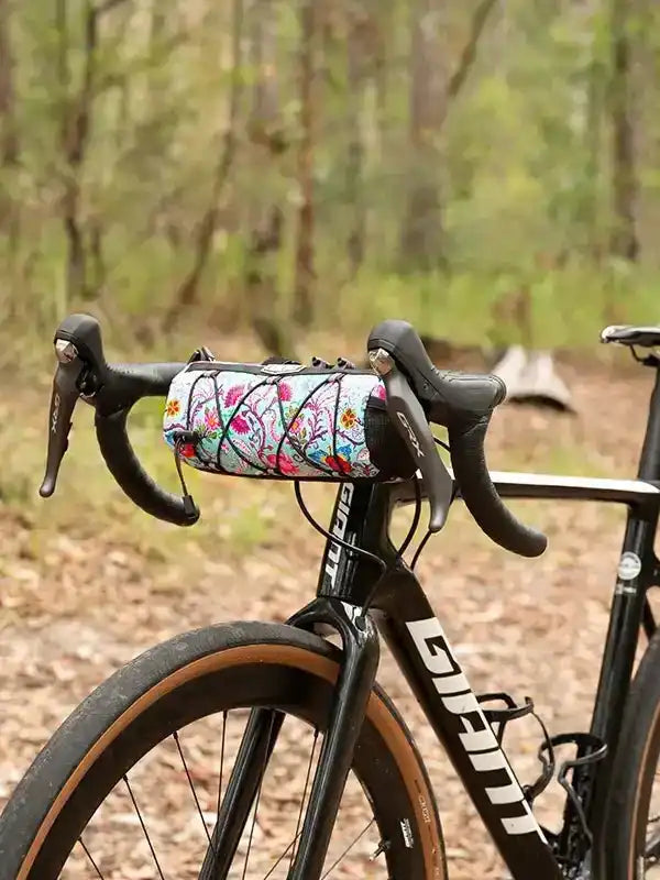 Floral bike frame bag on handlebars, perfect for cycling adventures in nature
