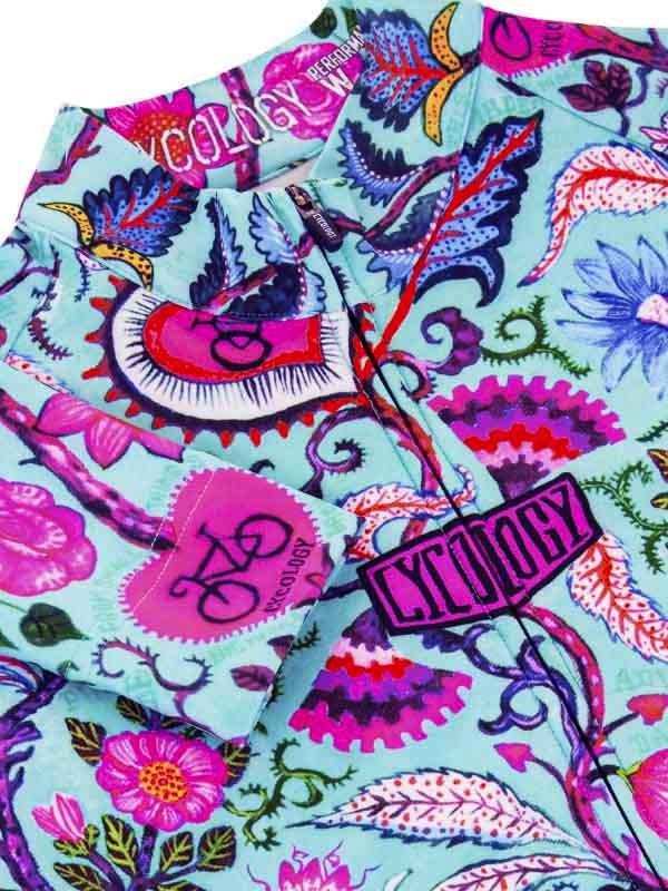 Vibrant floral and bicycle print cycling jersey with bold pink and blue patterns, ideal for women's cycling wear.