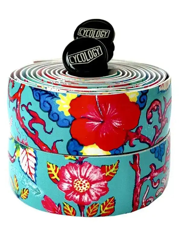 Colorful floral bike handlebar tape with Cycology end plugs, vibrant tropical design for cycling gear