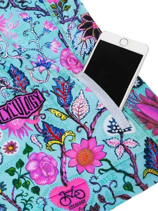 Cycling jersey with vibrant floral print and phone pocket, featuring bike logo and colorful botanical design