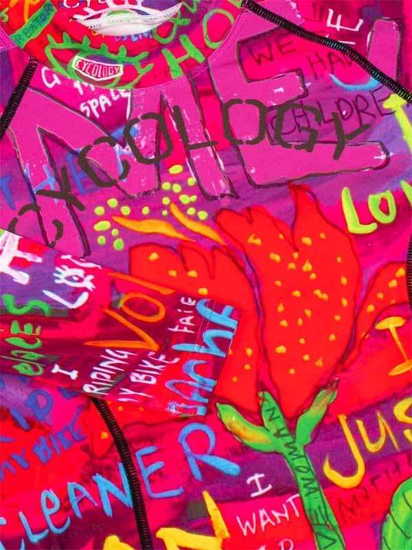 Vibrant pink cycling jersey with bold graffiti-style graphics, red tulip print, and playful text for women's bike wear.