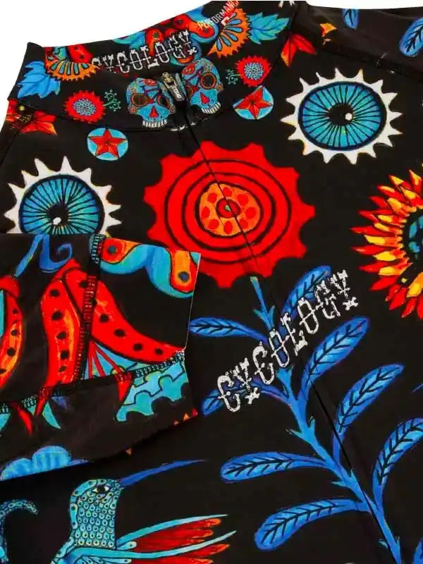 Vibrant cycling shorts with bold skull, sun, and hummingbird print on black fabric