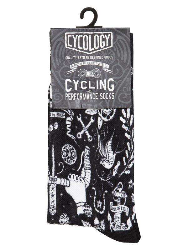 Black cycling performance socks with white tattoo-style graphics, including tools and birds, on hanger
