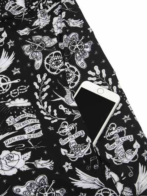 Black cycling jersey with white tattoo-style graphics, anchors, butterflies, and 'Ride No Matter The Weather' text