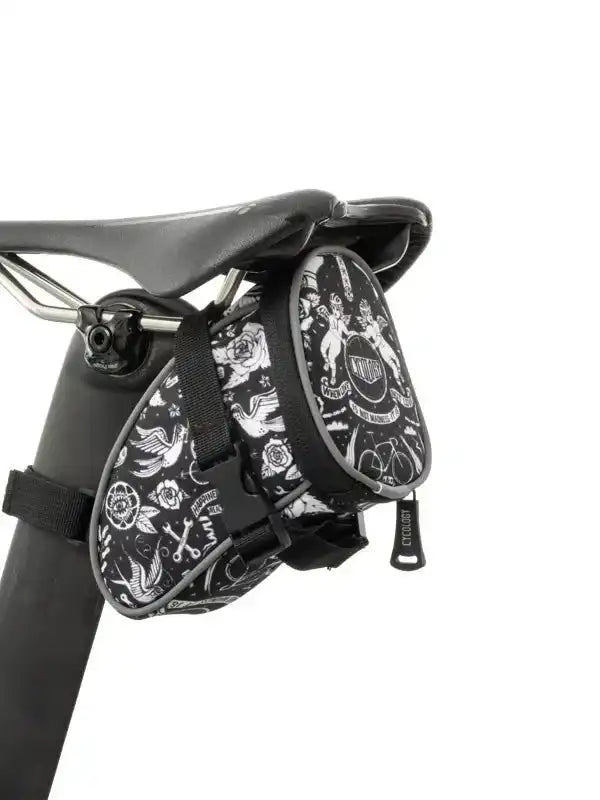 Black and white patterned cycling saddle bag with floral and bike designs, attached to bike seat