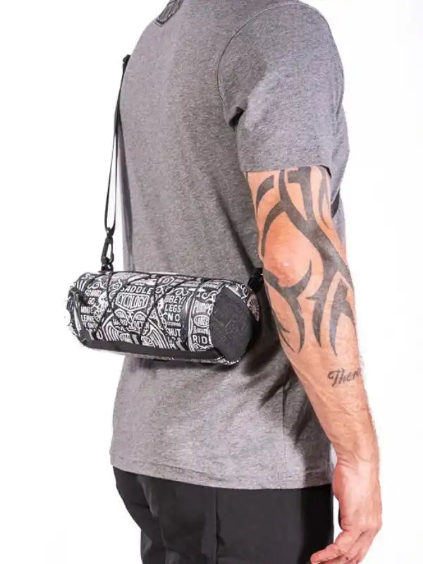 Cycling waist bag with bold graphic print, worn by man in grey tee, ideal for bike rides and outdoor adventures.